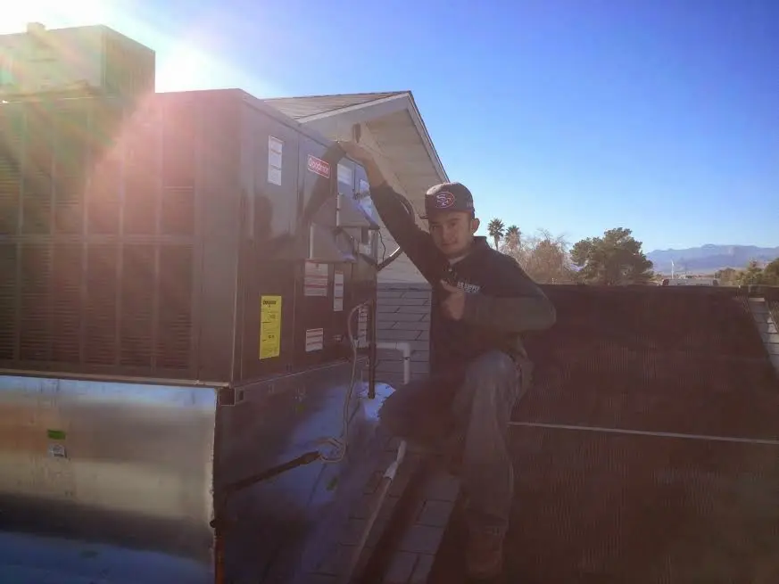 HVAC technician performing AC Tune-Up on a rooftop unit in Wytheville